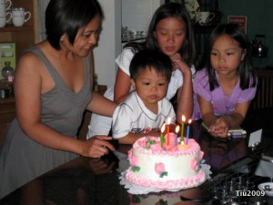 Blowing out the candles on Mom's cake